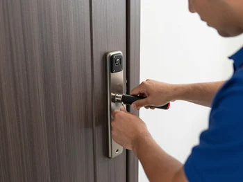 Locksmith installing new deadbolt lock on residential home in Phoenix area